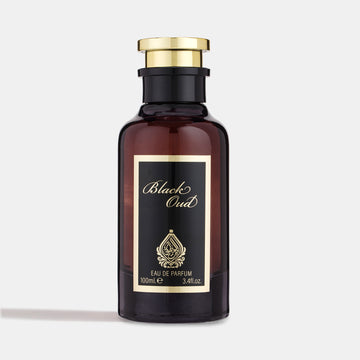 A dark amber glass perfume bottle with a gold-colored cap, labeled 'Black Oud Eau de Parfum 100ml'.