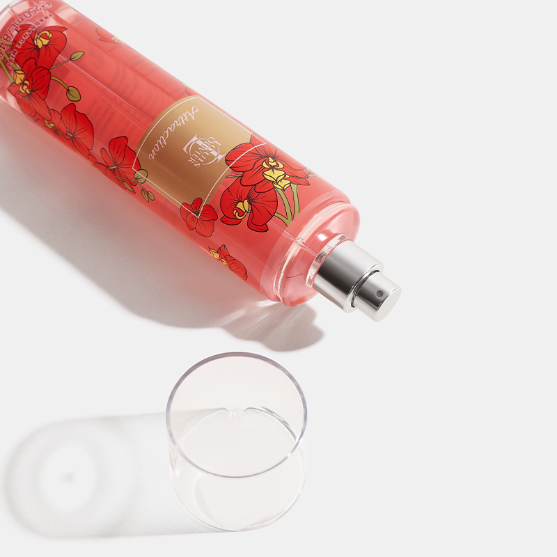Attraction Red floral bottle with a clear glass on a white background