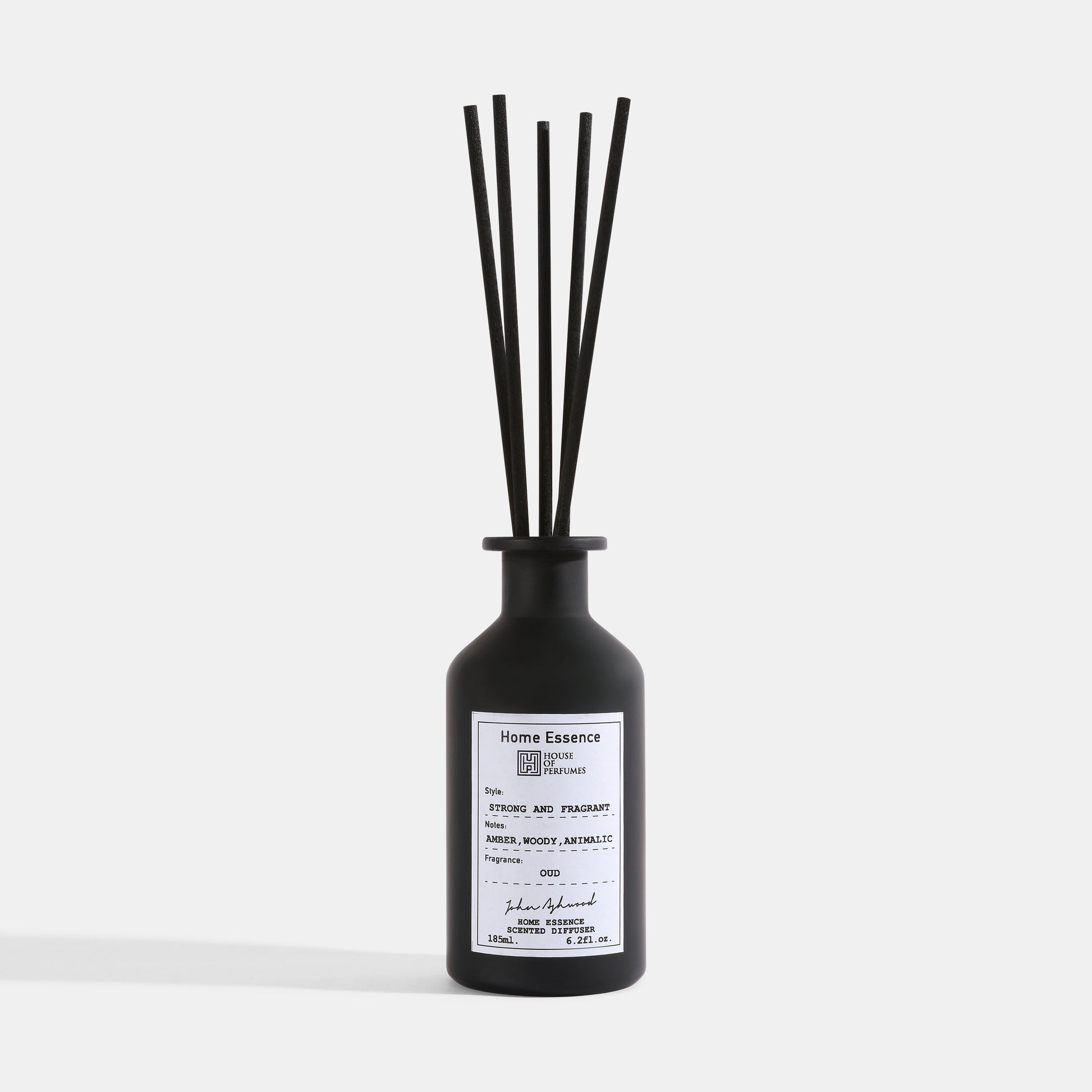 Black diffuser bottle with sticks on a white background