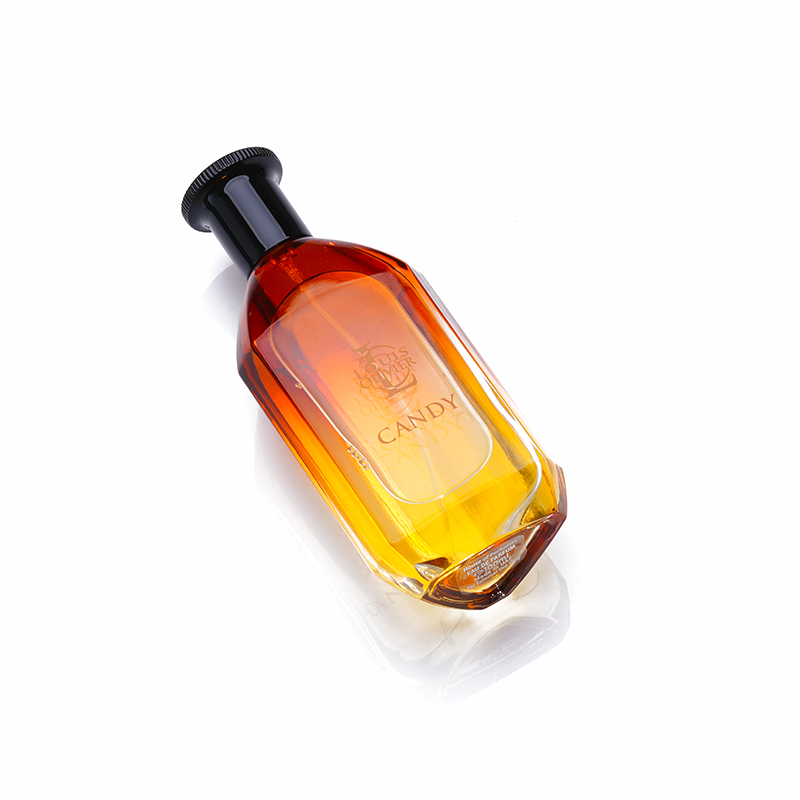 Candy - Amber-colored bottle with a black cap on a white background. House Of Perfumes India