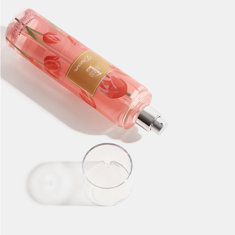 Dream Pink bottle with cherry design and a glass on a white background. House Of Perfumes India