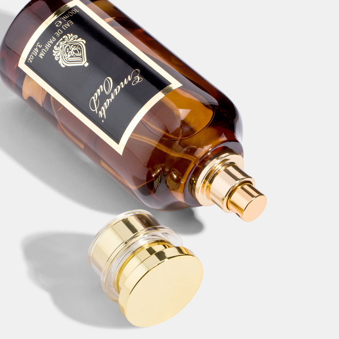 A bottle of Emirati Oud perfume with a gold-colored cap and a black label displaying the product name and fragrance type 'Eau de Parfum'.