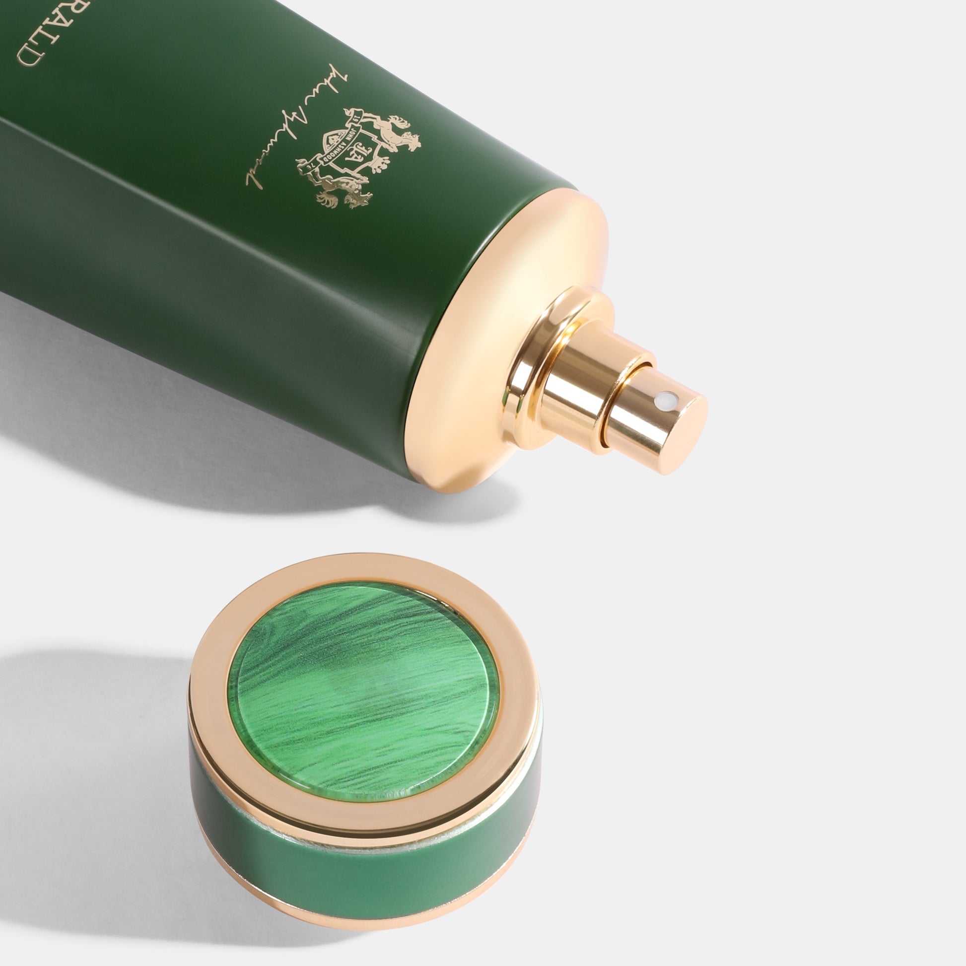 EMERALD Green and gold perfume bottle with a visible brand logo on a white background