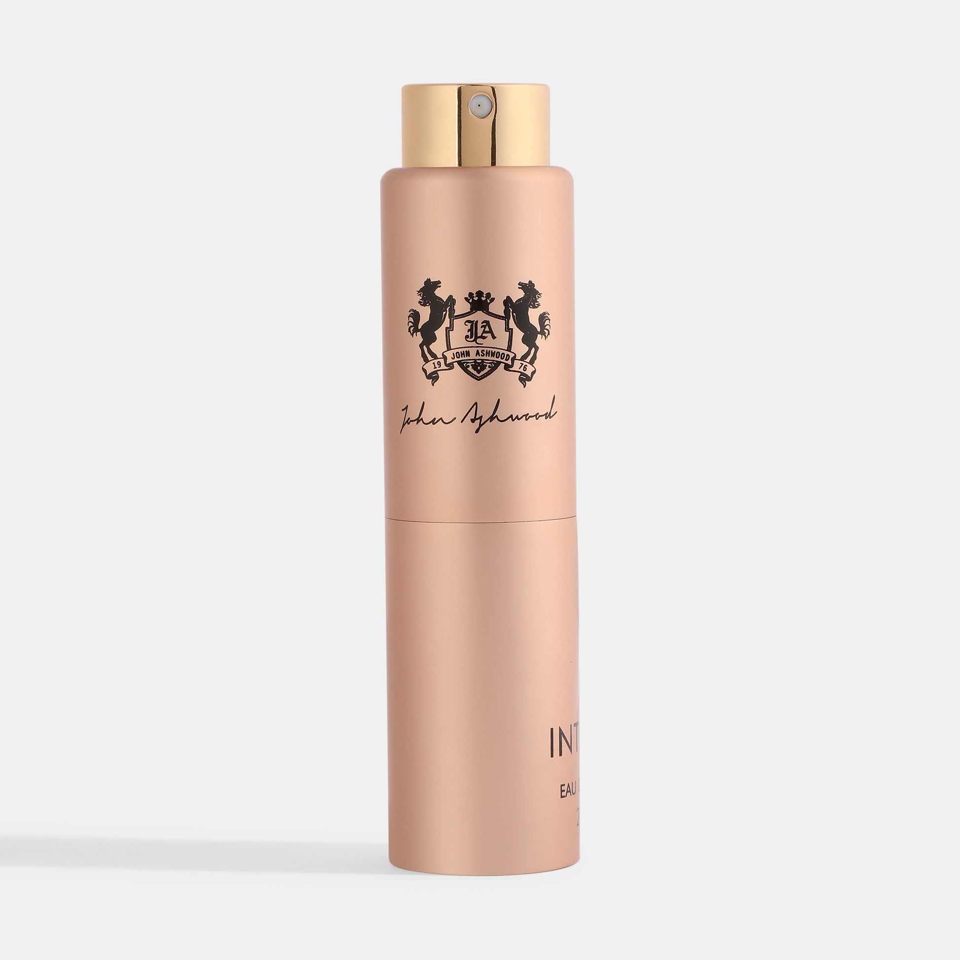 INTENSO perfume bottle with gold cap on a light gray background