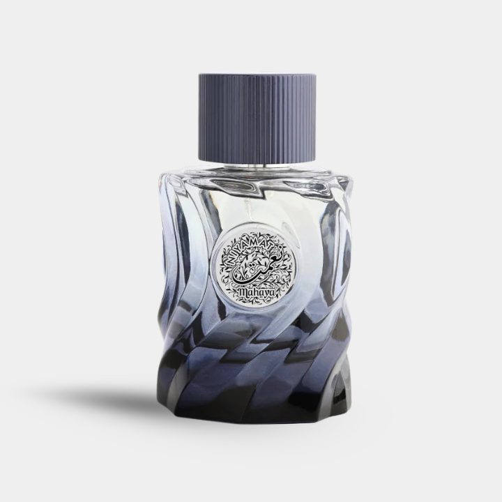 A faceted glass perfume bottle with a dark blue gradient and a ribbed dark cap, featuring a silver circular emblem on the front.