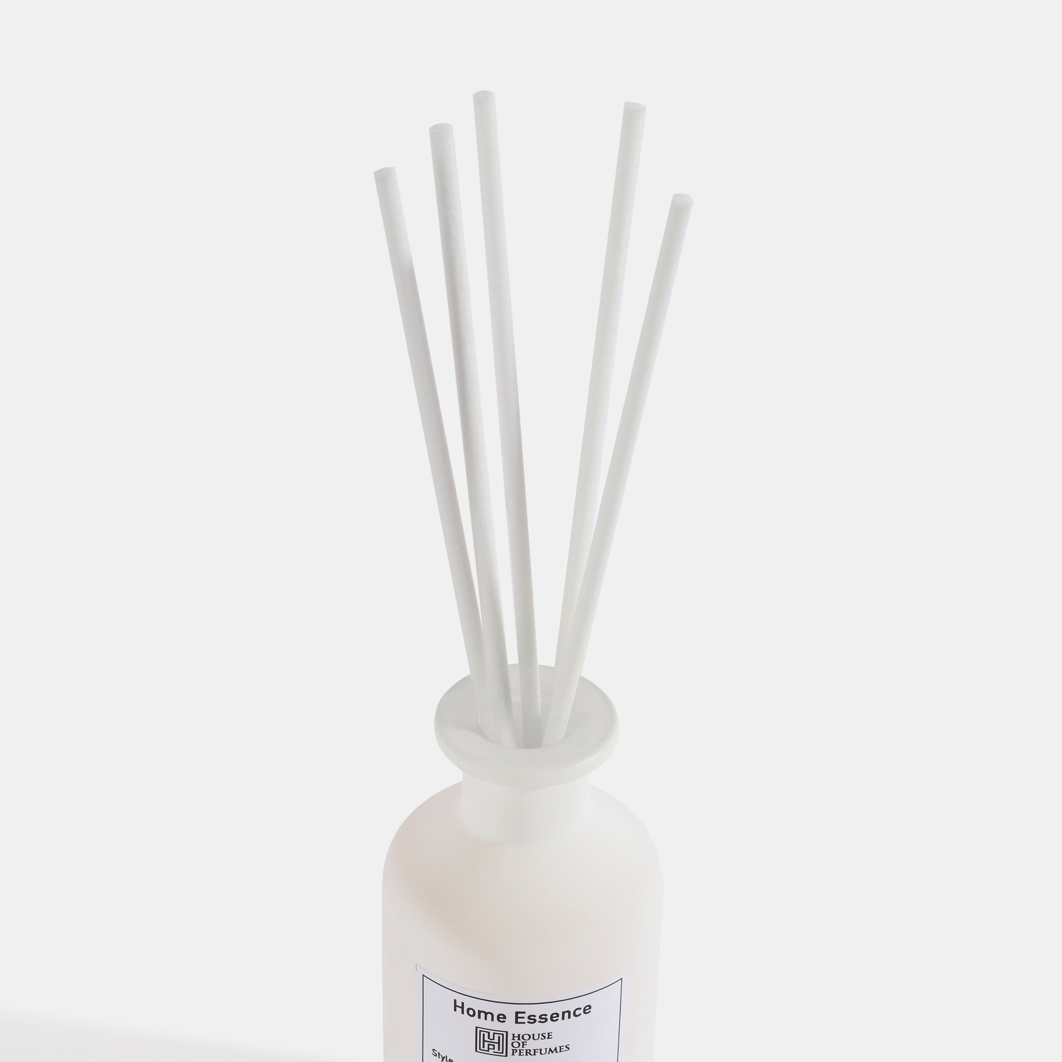 White diffuser bottle with reeds on a white background
