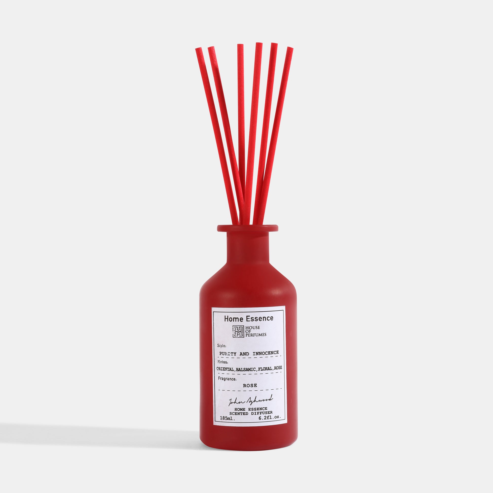 Red diffuser bottle with red sticks on a white background