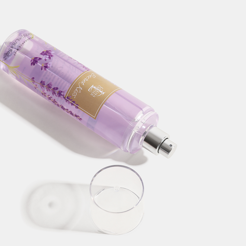 Secret Kiss Purple bottle with a gold label next to a clear glass on a white background. House Of Perfumes India