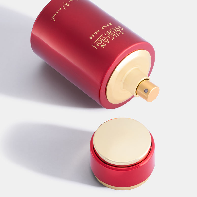 Red canister with gold lid labeled 'Tuscan Collection Dark Rose' on a light gray background