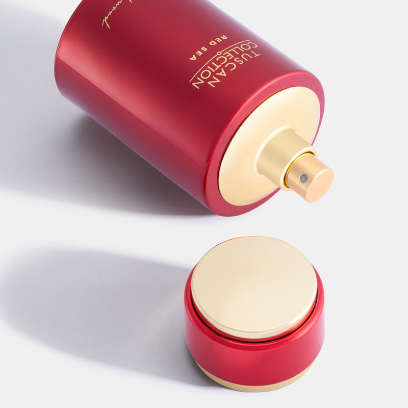 Red container with gold lid labeled 'Tuscan Collection Red Sea' on a light gray background